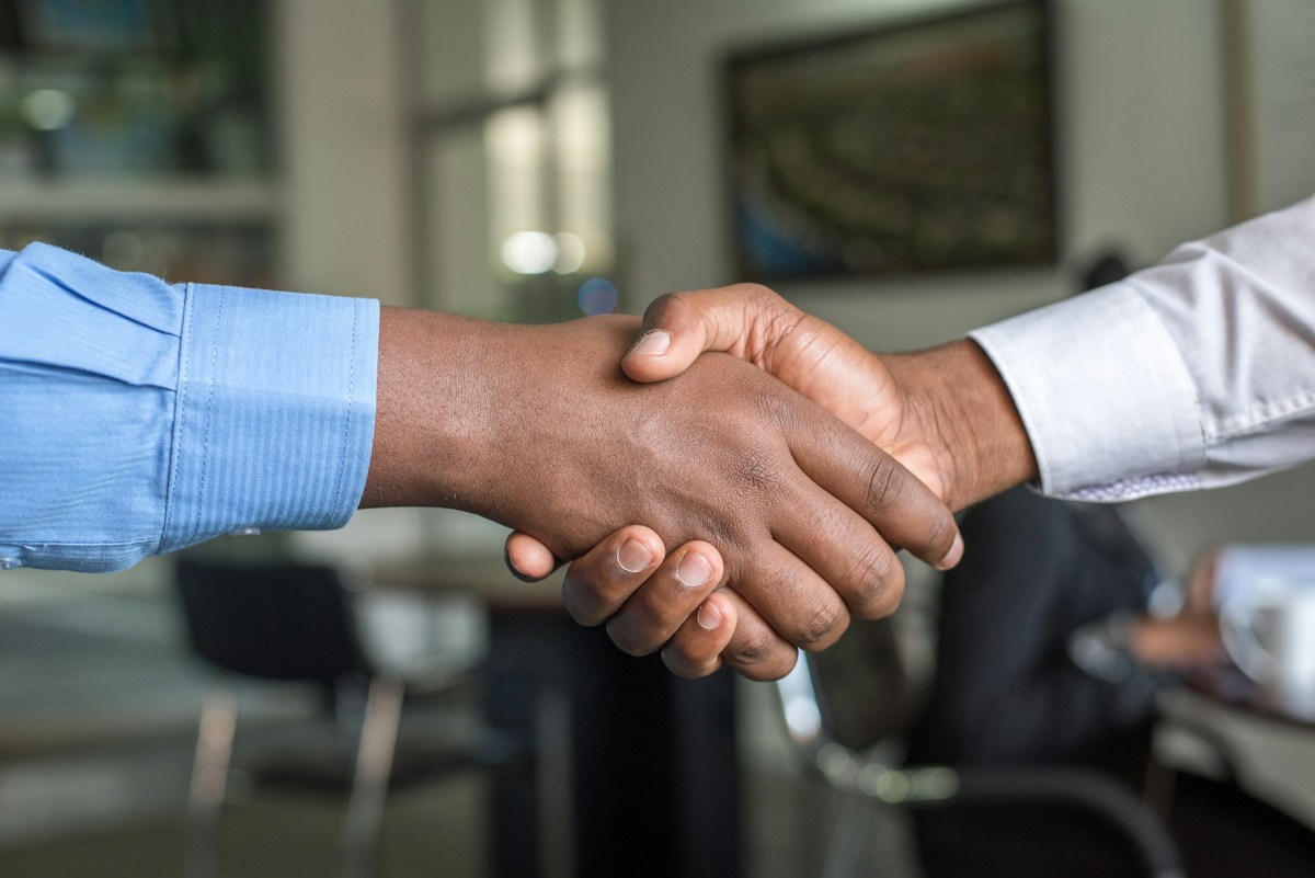 A professional handshake representing stakeholder confidence and trusted relationships
